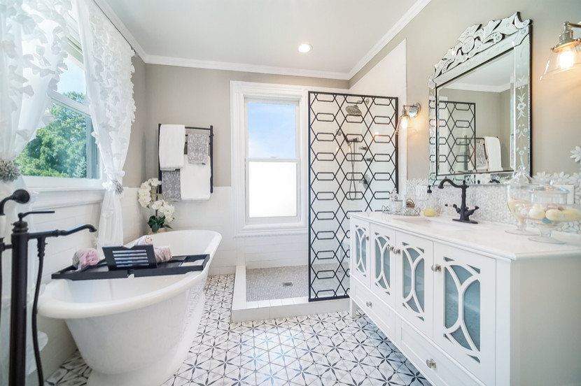 This is an example of a mid-sized contemporary master bathroom in Columbus with glass-front cabinets, white cabinets, a freestanding tub, an open shower, white tile, ceramic tile, porcelain floors, a drop-in sink, grey floor, an open shower, a single vanity, a freestanding vanity and decorative wall panelling.