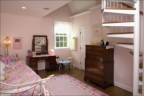 Mid-sized traditional kids' bedroom in DC Metro with dark hardwood floors and pink walls for girls.