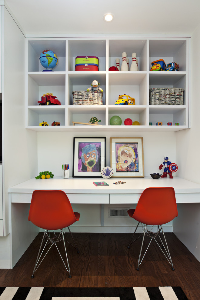 This is an example of a contemporary gender-neutral kids' study room in San Francisco with white walls and dark hardwood floors.