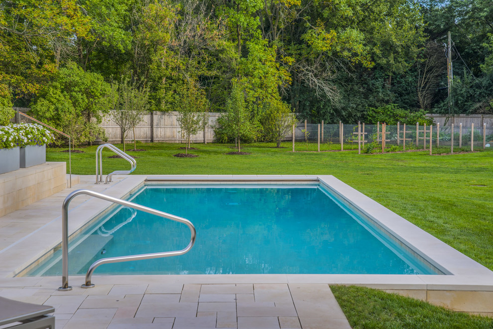Inspiration for a mid-sized backyard stone and rectangular pool remodel in Chicago