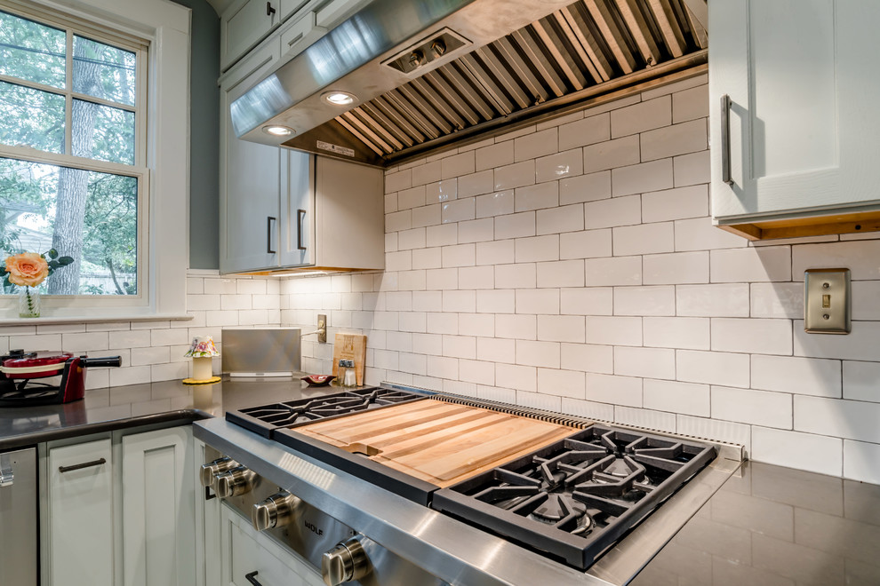 Enclosed kitchen - mid-sized traditional galley porcelain tile enclosed kitchen idea in Miami with an undermount sink, shaker cabinets, gray cabinets, quartz countertops, white backsplash, subway tile backsplash, stainless steel appliances and no island