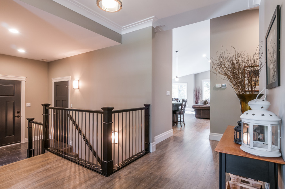 This is an example of a mid-sized arts and crafts hallway in Toronto with grey walls and dark hardwood floors.