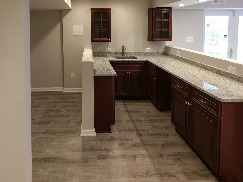 Design ideas for a basement in DC Metro with grey walls, laminate floors and grey floor.