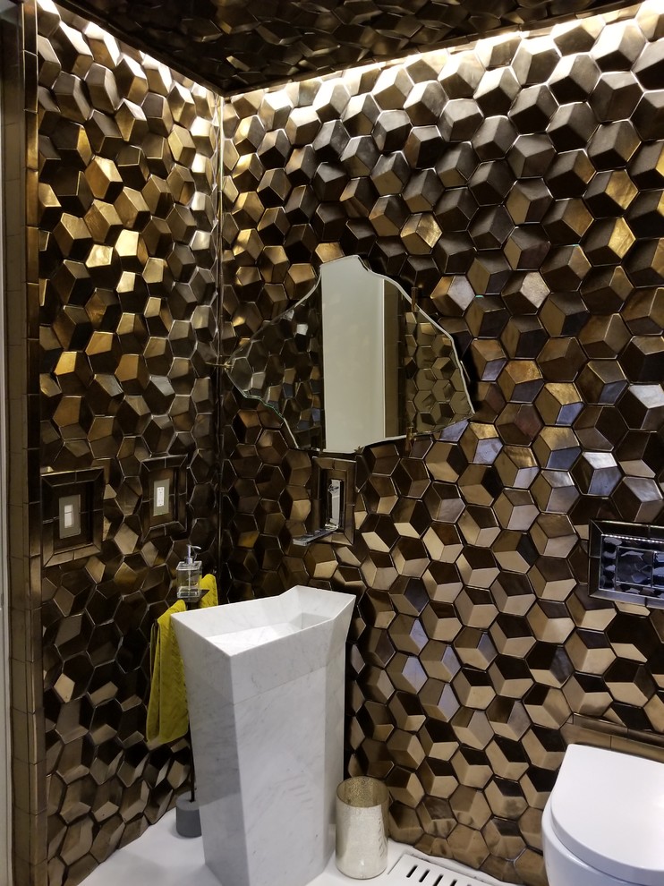 This is an example of a small contemporary powder room in San Francisco with a wall-mount toilet, brown walls, a pedestal sink and white floor.