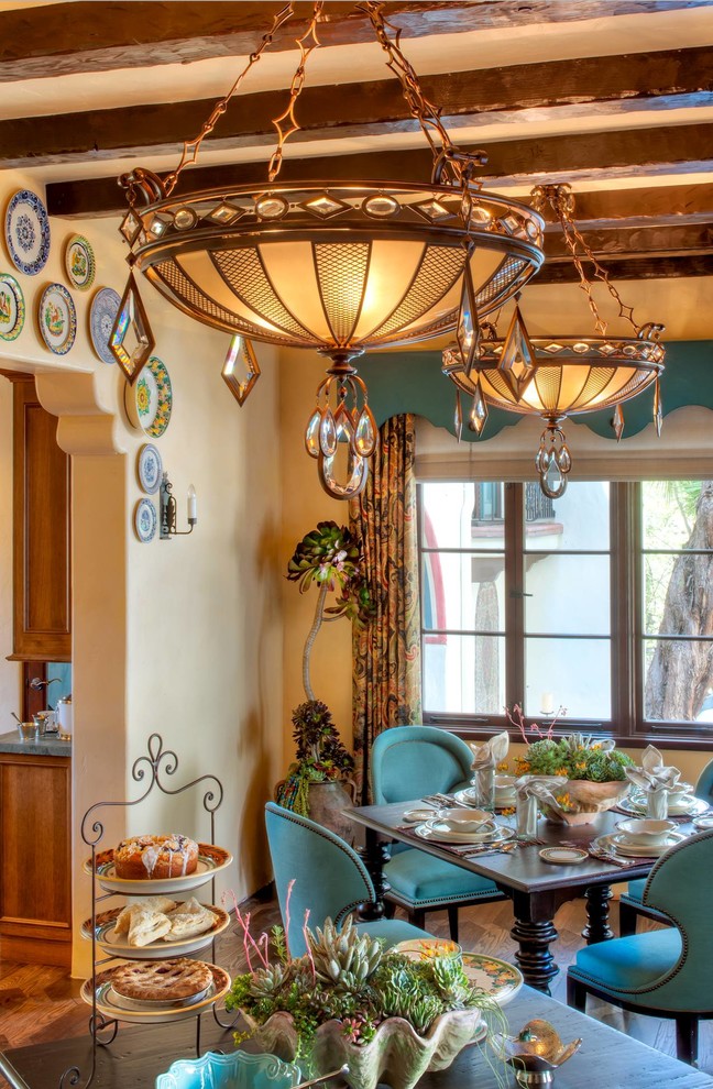 Mediterranean dining room in Los Angeles with beige walls and dark hardwood floors.
