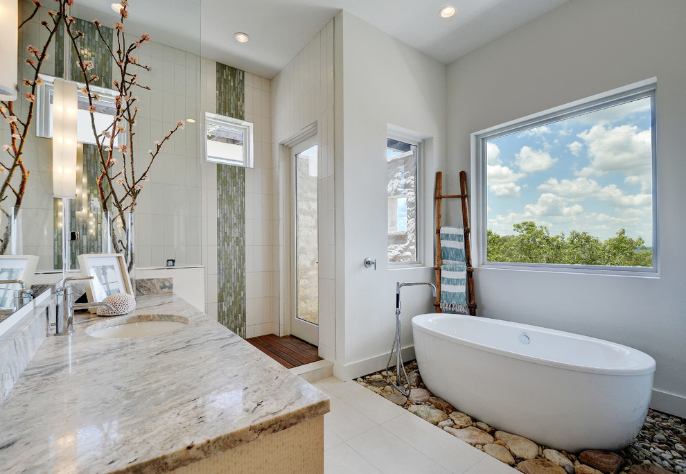 This is an example of a mid-sized contemporary master bathroom in Austin with an undermount sink, flat-panel cabinets, beige cabinets, quartzite benchtops, a freestanding tub, an open shower, white tile, glass tile, white walls and porcelain floors.