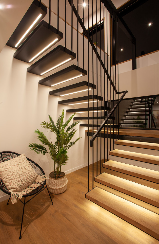 Contemporary wood u-shaped staircase in Hobart with open risers and metal railing.