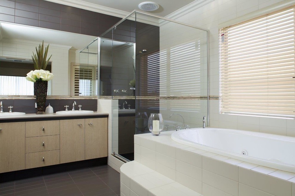Contemporary master bathroom in Perth with flat-panel cabinets, beige cabinets, a drop-in tub, a corner shower, a one-piece toilet, beige tile, ceramic tile, beige walls, ceramic floors, a vessel sink, laminate benchtops, brown floor, a hinged shower door, beige benchtops, an enclosed toilet, a double vanity and a built-in vanity.