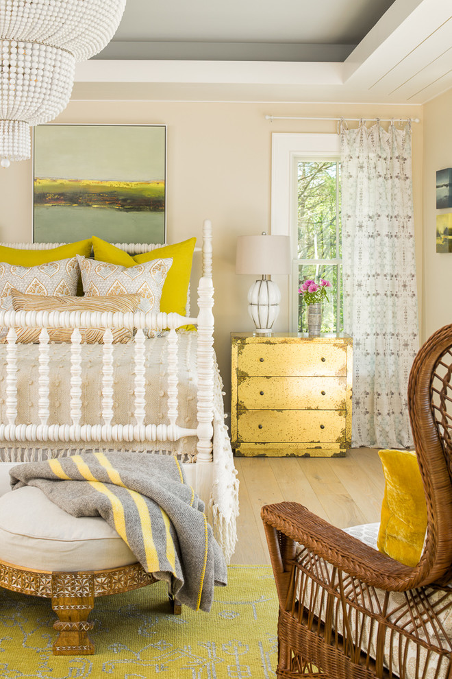 Inspiration for a beach style bedroom in Portland Maine with beige walls, light hardwood floors and beige floor.