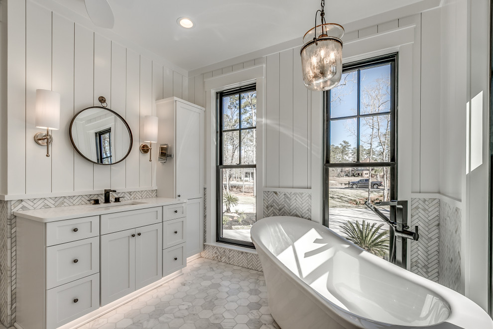 Inspiration for a transitional master bathroom in Charleston with shaker cabinets, white cabinets, a freestanding tub, marble, white walls, marble floors, an undermount sink, grey floor, white benchtops, a single vanity, a built-in vanity and panelled walls.