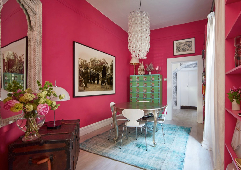 Small eclectic separate dining room in Melbourne with pink walls and light hardwood floors.