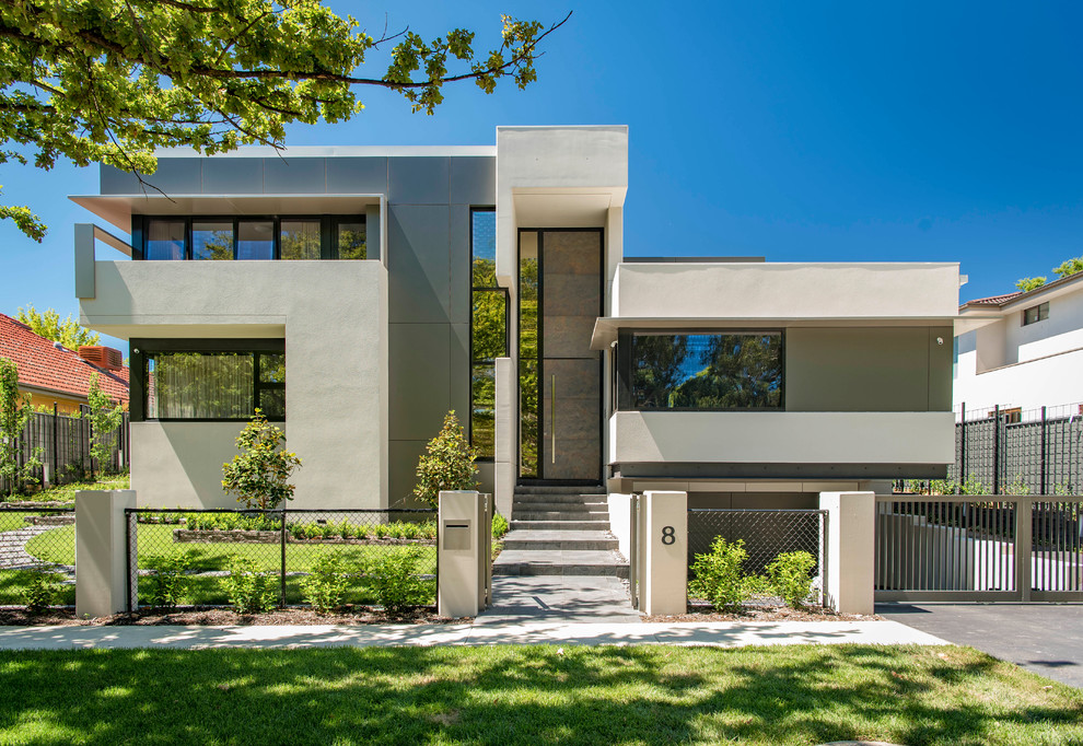 Photo of a contemporary two-storey concrete beige house exterior in Canberra - Queanbeyan with a flat roof.