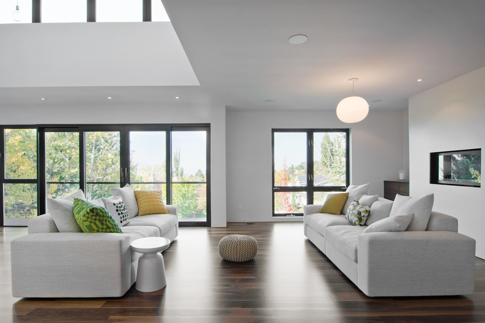 Modern open concept living room in Salt Lake City with white walls.