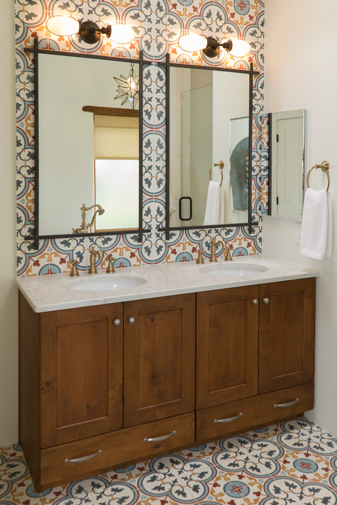 Inspiration for a mid-sized master bathroom in Phoenix with recessed-panel cabinets, medium wood cabinets, a freestanding tub, a curbless shower, a two-piece toilet, white tile, porcelain tile, white walls, cement tiles, an undermount sink, engineered quartz benchtops, multi-coloured floor, a hinged shower door and white benchtops.