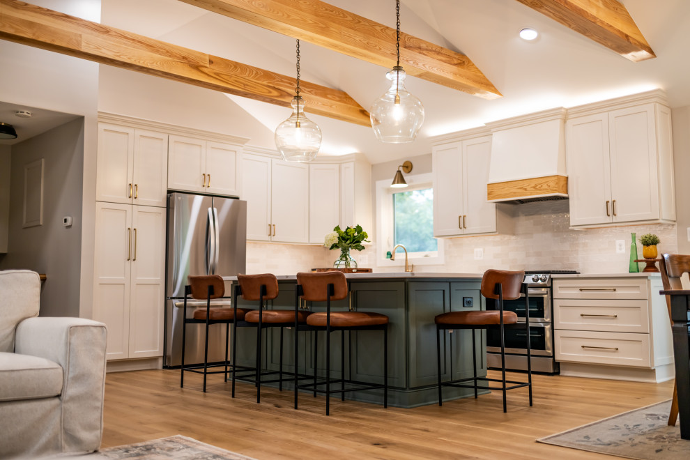 Example of a large transitional l-shaped light wood floor, brown floor and exposed beam eat-in kitchen design in DC Metro with an undermount sink, shaker cabinets, quartz countertops, white backsplash, porcelain backsplash, stainless steel appliances, an island and white countertops
