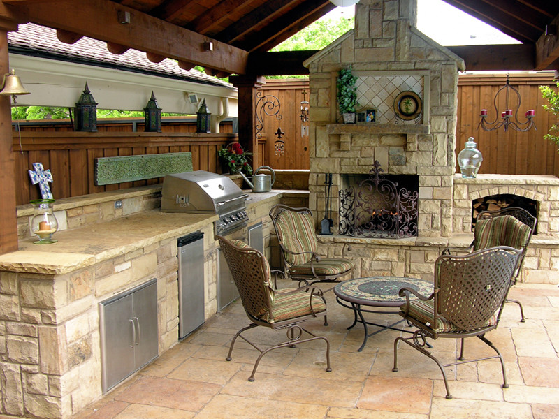Mid-sized traditional backyard patio in Dallas with an outdoor kitchen, natural stone pavers and a gazebo/cabana.