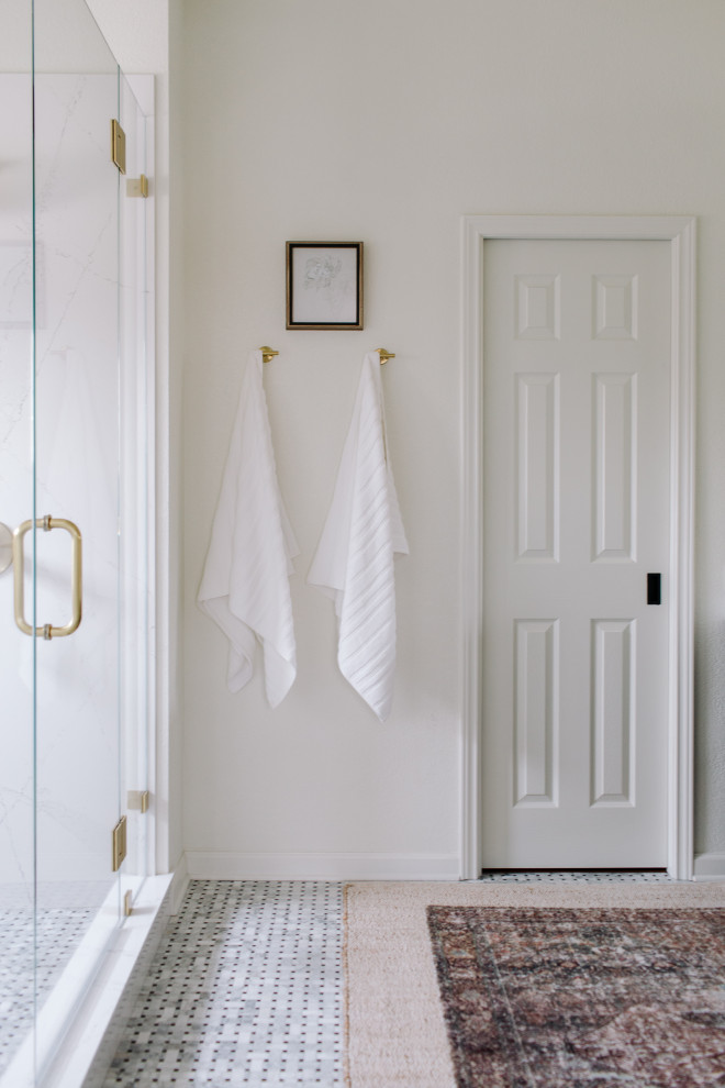 Example of a transitional marble tile porcelain tile alcove shower design in Dallas with a hinged shower door