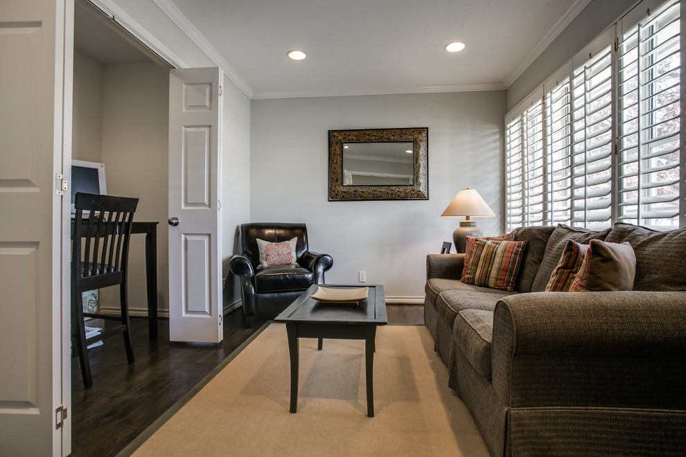 This is an example of a mid-sized traditional study room in Dallas with grey walls, dark hardwood floors, no fireplace and a freestanding desk.