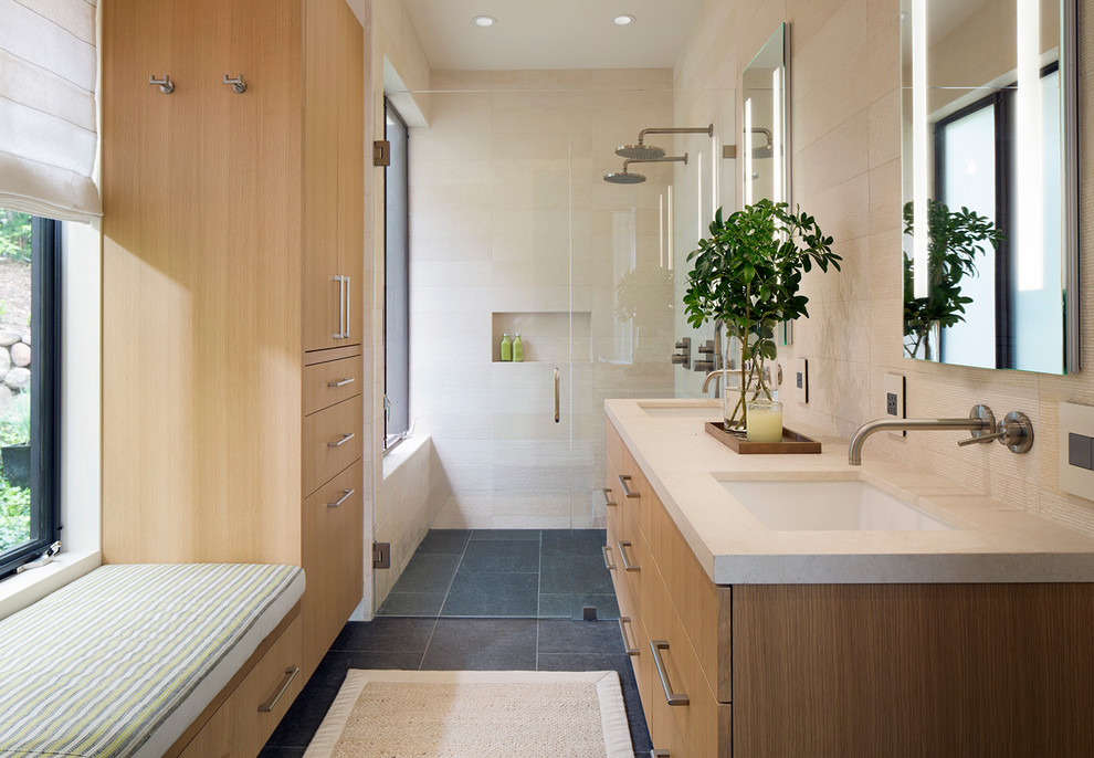 Contemporary master bathroom in San Francisco with flat-panel cabinets, light wood cabinets, a double shower, beige tile, stone tile, slate floors, an undermount sink, limestone benchtops, a hinged shower door and beige benchtops.