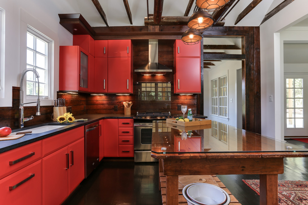 This is an example of a small country l-shaped open plan kitchen in Raleigh with a single-bowl sink, flat-panel cabinets, red cabinets, granite benchtops, brown splashback, stainless steel appliances, dark hardwood floors, with island and timber splashback.