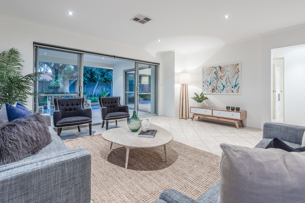 This is an example of a transitional living room in Perth with white walls and no tv.