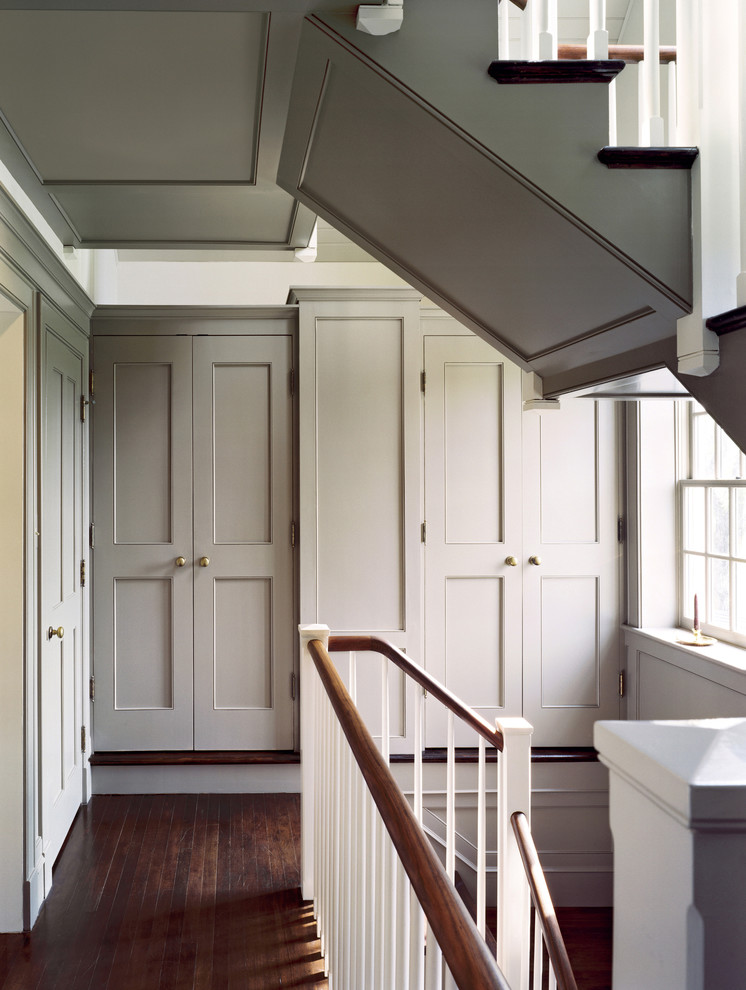 Inspiration for a small country hallway in DC Metro with dark hardwood floors, grey walls and brown floor.