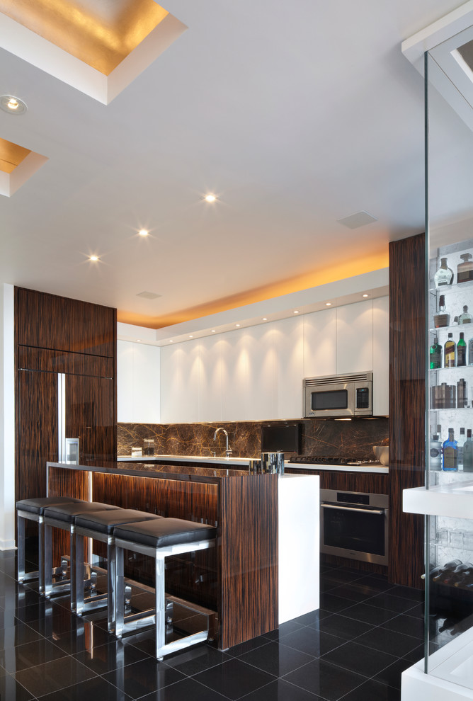Design ideas for a mid-sized contemporary l-shaped open plan kitchen in New York with flat-panel cabinets, dark wood cabinets, grey splashback, stainless steel appliances, an undermount sink, a peninsula, quartz benchtops, stone slab splashback, porcelain floors and black floor.