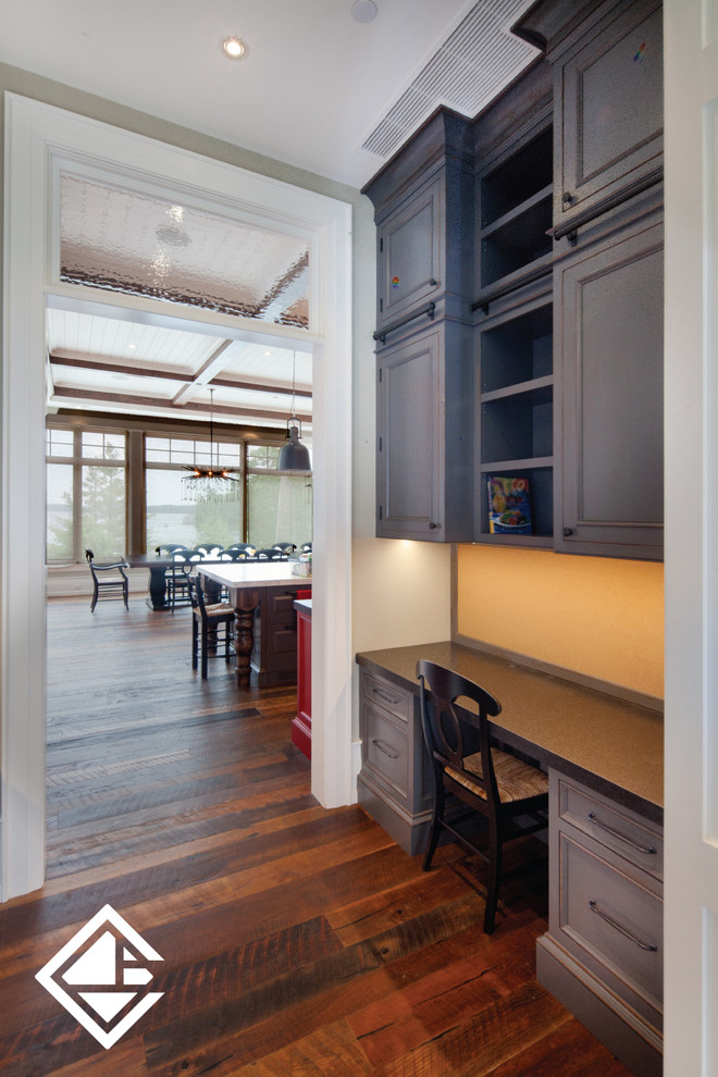 Inspiration for a huge rustic l-shaped medium tone wood floor eat-in kitchen remodel with a farmhouse sink, raised-panel cabinets, granite countertops, white backsplash, an island, gray cabinets and stainless steel appliances