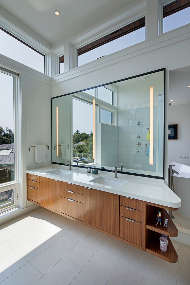 This is an example of a large contemporary master bathroom in Los Angeles with flat-panel cabinets, dark wood cabinets, a freestanding tub, an open shower, a wall-mount toilet, glass tile, porcelain floors, an undermount sink, engineered quartz benchtops and yellow benchtops.
