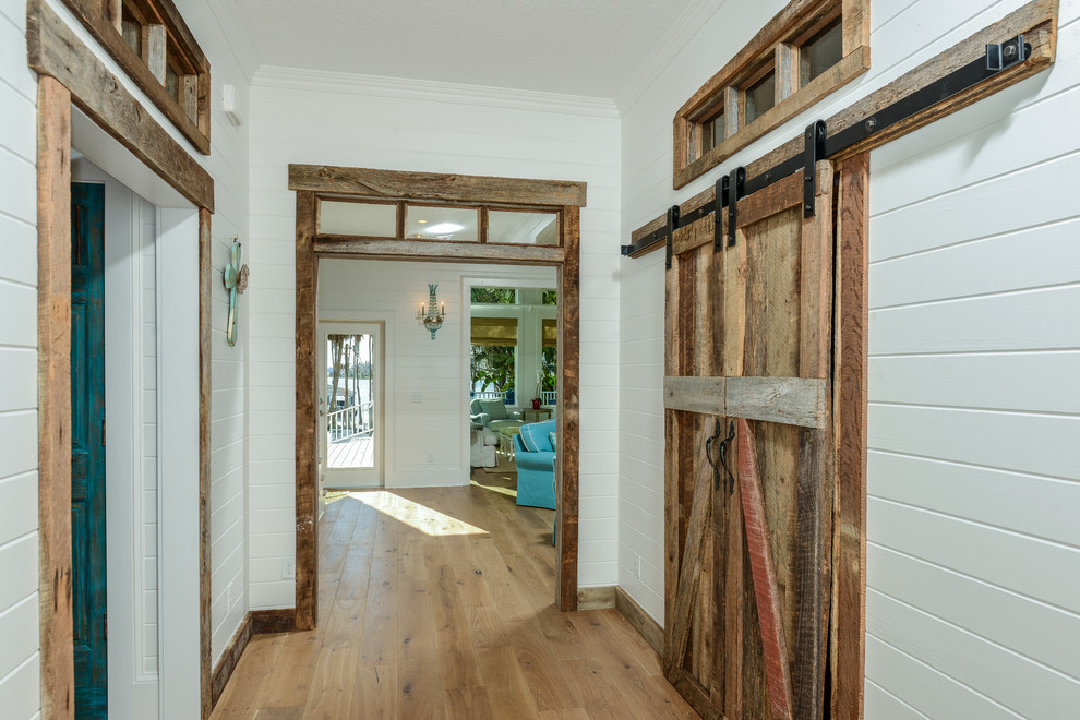 This is an example of a large country foyer in Tampa with light hardwood floors.