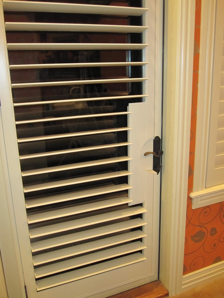 Entryway - transitional entryway idea with orange walls and a white front door