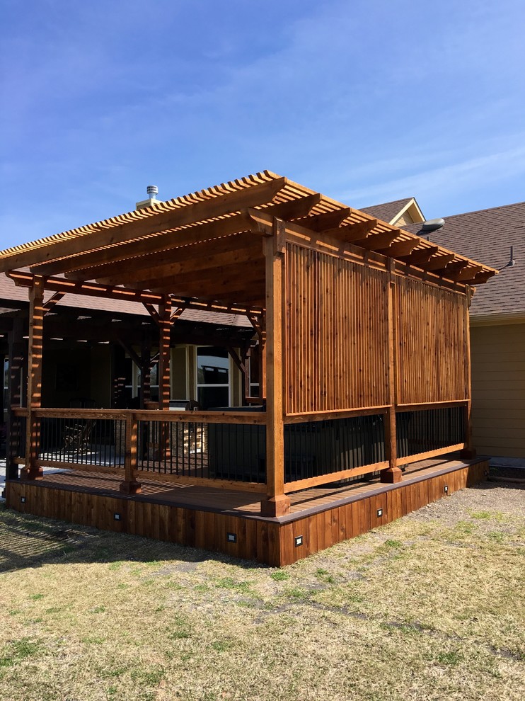 Inspiration for a mid-sized timeless backyard deck remodel in Other with a pergola