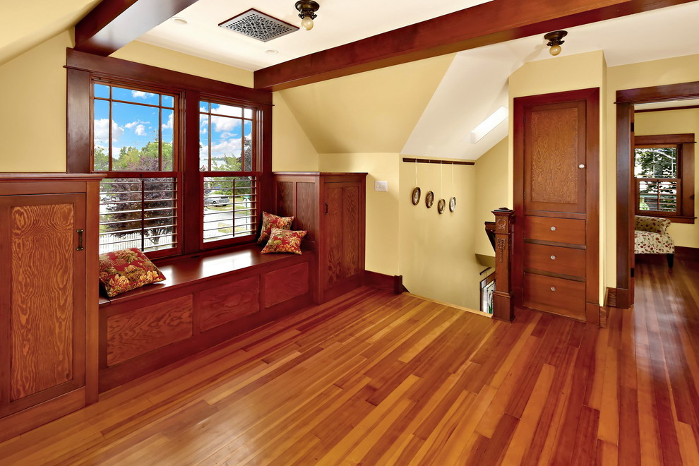 Large traditional hallway in Seattle with yellow walls, medium hardwood floors and brown floor.