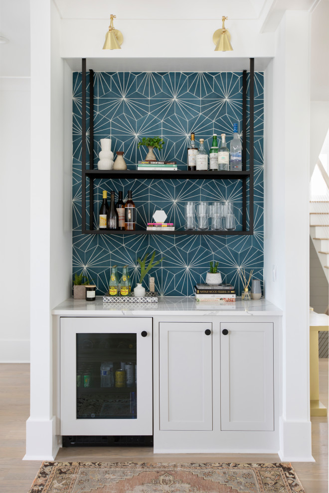 Beach style single-wall bar cart in Charleston with shaker cabinets, grey cabinets, blue splashback, light hardwood floors, beige floor and white benchtop.