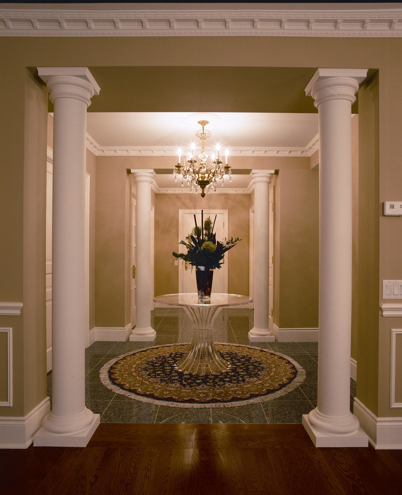 Design ideas for a mid-sized traditional foyer in Toronto with beige walls, granite floors, a single front door and a white front door.