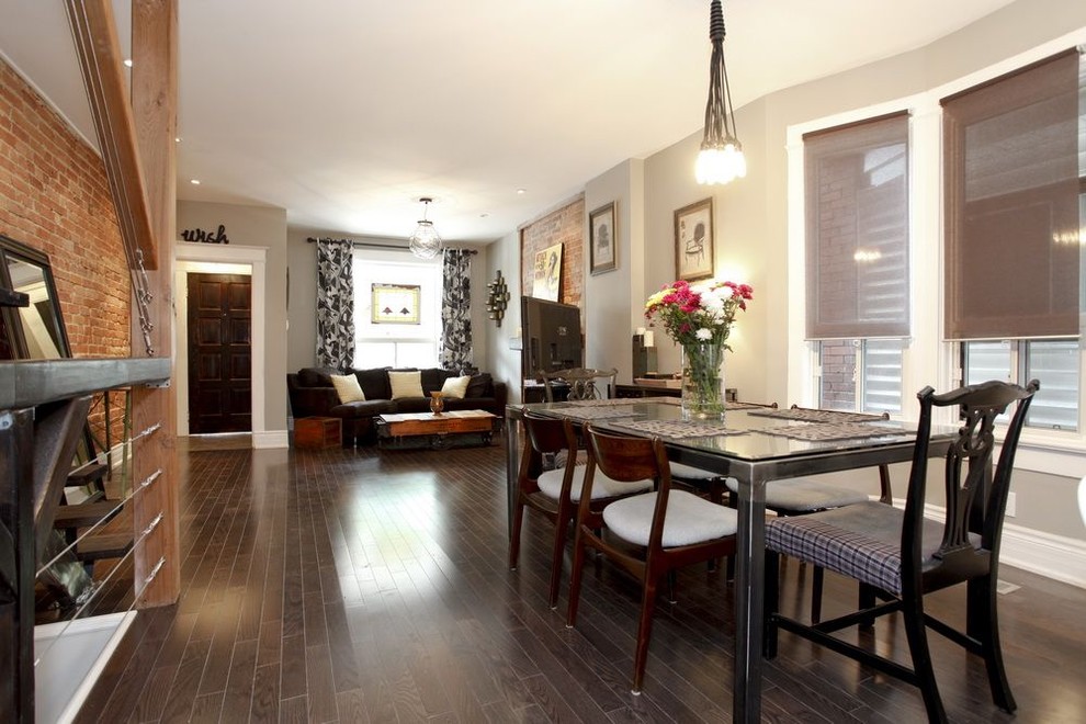 This is an example of an eclectic dining room in Toronto with grey walls and dark hardwood floors.