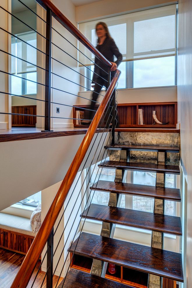 Mid-sized contemporary wood straight staircase in New York with open risers.