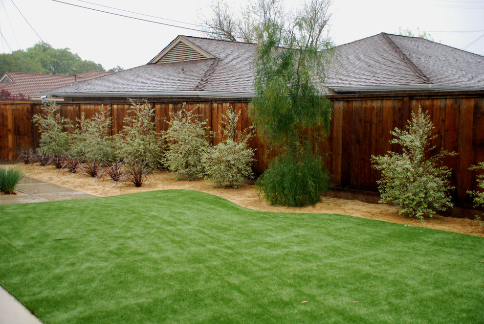 This is an example of a mid-sized traditional backyard full sun garden in San Francisco with concrete pavers.