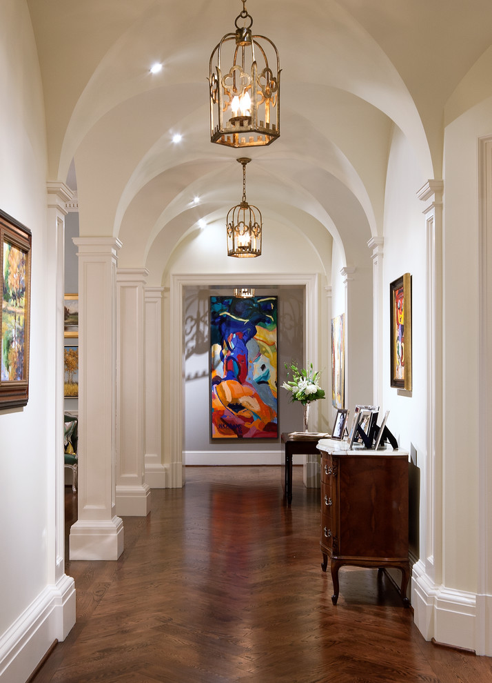 Photo of a large traditional hallway in Atlanta with white walls, dark hardwood floors and brown floor.