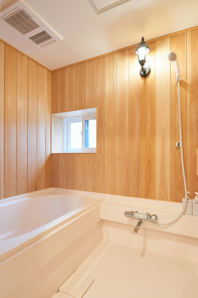 This is an example of a mid-sized country master bathroom in Tokyo with a hot tub, brown walls, linoleum floors, white floor, a freestanding vanity, timber and wood walls.