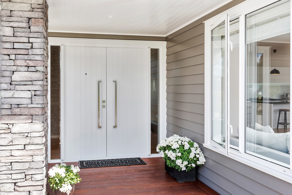 Photo of a large transitional front door in Hamilton with a double front door and a white front door.