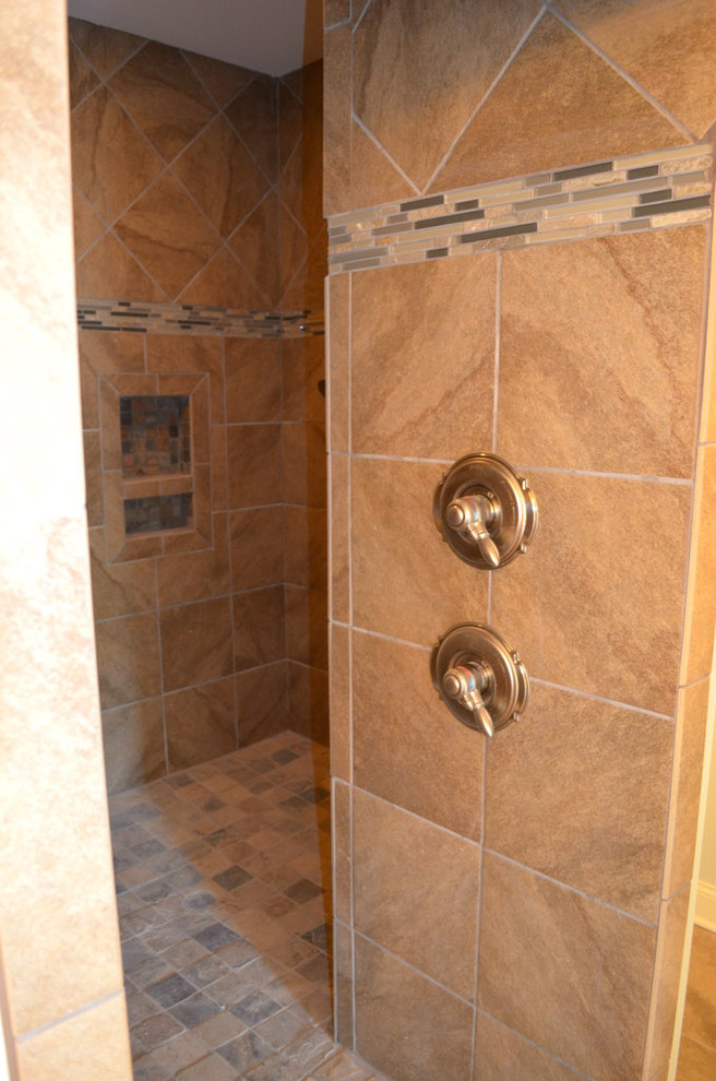 Photo of a mid-sized traditional 3/4 bathroom in Birmingham with medium wood cabinets, multi-coloured tile, ceramic tile, beige walls, ceramic floors, an undermount sink and granite benchtops.