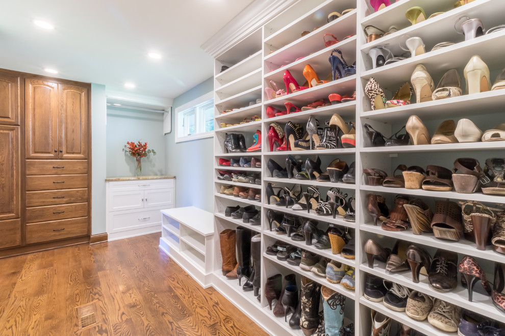 Inspiration for a large traditional gender-neutral dressing room in Minneapolis with shaker cabinets, white cabinets and medium hardwood floors.