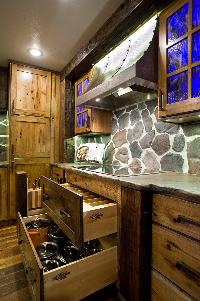 Eat-in kitchen - mid-sized rustic l-shaped medium tone wood floor eat-in kitchen idea with a farmhouse sink, shaker cabinets, distressed cabinets, concrete countertops, gray backsplash, stone slab backsplash, stainless steel appliances and an island