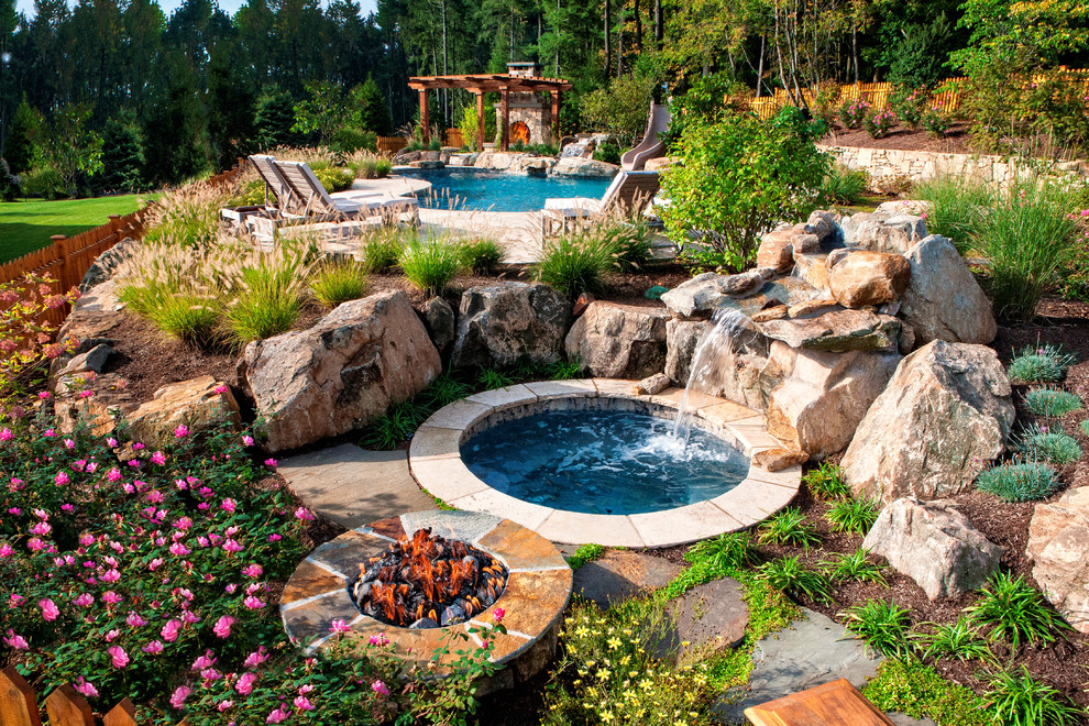 Inspiration for a traditional backyard custom-shaped lap pool in New York with a water slide and tile.