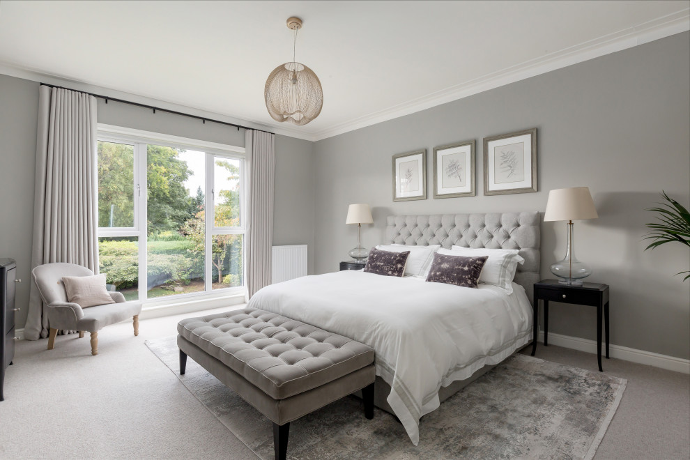 Large traditional master bedroom in Edinburgh with grey walls, carpet, no fireplace and wallpaper.