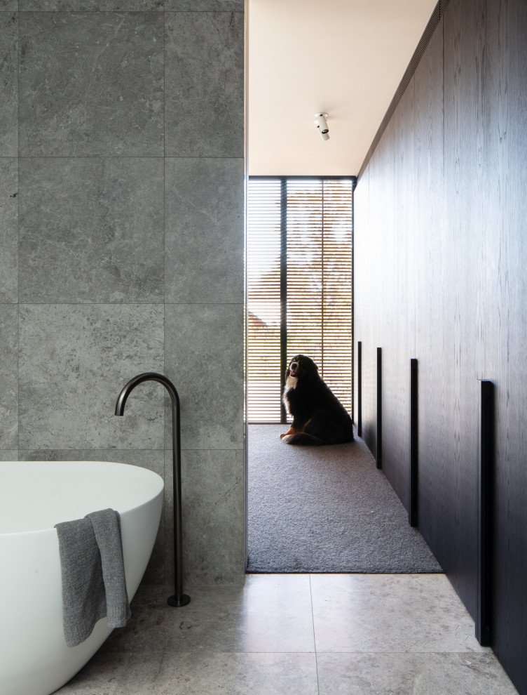 Photo of a modern master bathroom in Melbourne with a freestanding tub.