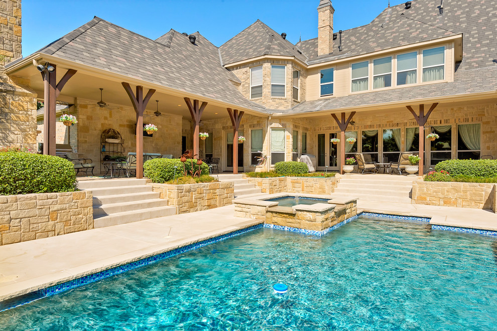 Photo of a traditional backyard rectangular pool in Dallas with a hot tub.