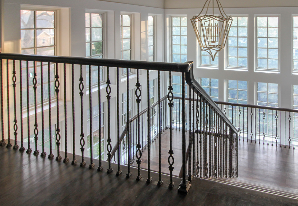 Large transitional wood floating staircase in DC Metro with wood risers and glass railing.