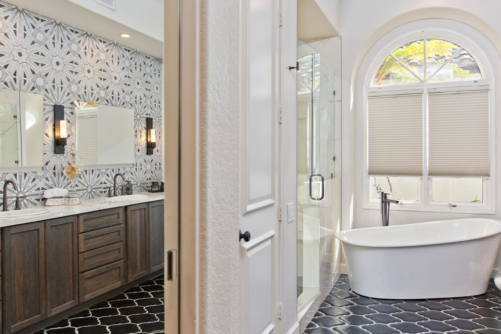 Large transitional master brown tile and terra-cotta tile terra-cotta tile freestanding bathtub photo in Denver with recessed-panel cabinets, distressed cabinets, a wall-mount toilet, white walls, an undermount sink and quartz countertops